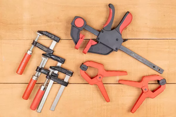 Woodworking Clamps on the wooden table background