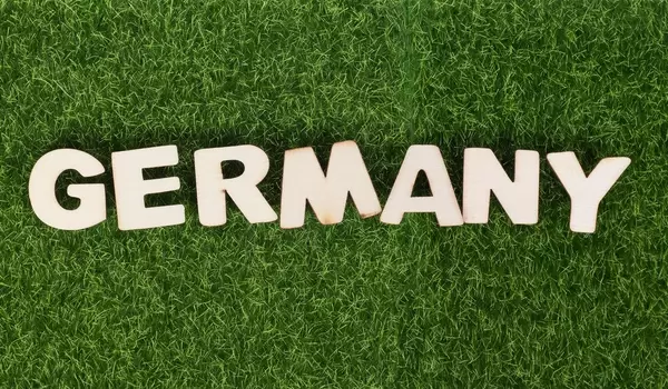 Word Germany on green grass background