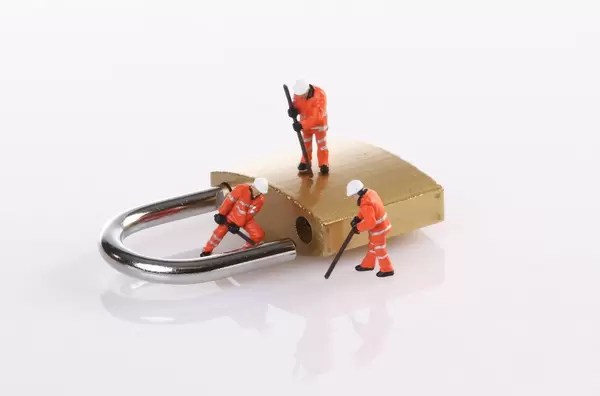 Workers hacking in padlock security