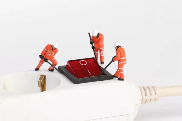 Workers on white electric splitter with red switch