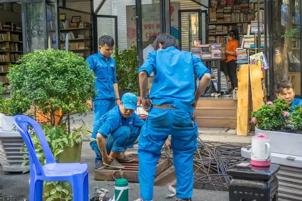 Workers working on Power Lines in Bookstreet in Ho Chi Minh City