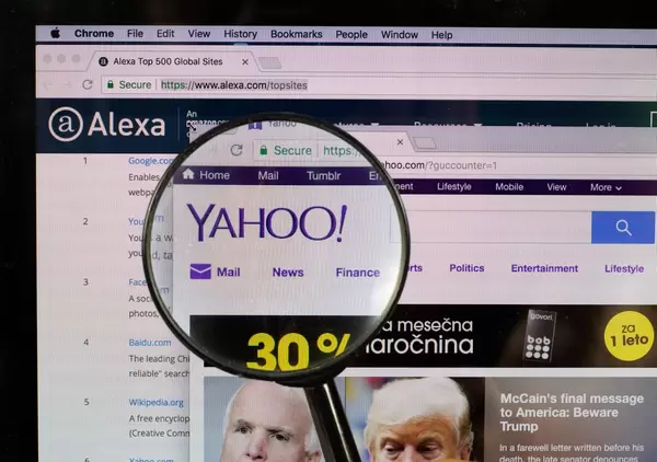 Yahoo logo on a computer screen with a magnifying glass