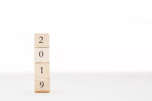 Year 2019 in focus: digits on four wooden cubes stacked up on top of each other