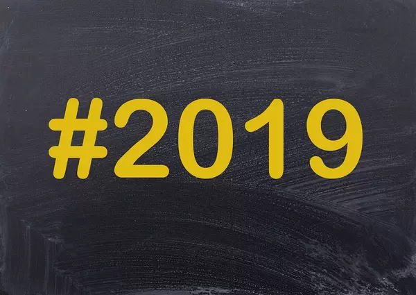 Year #2019 written on a black chalk board as hashtag