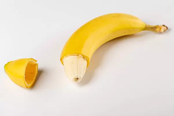 Yellow banana with no peel at the tip