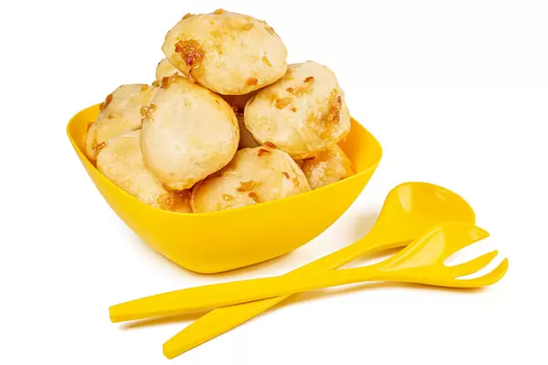 Yellow bowl with homemade dumplings with fried onions