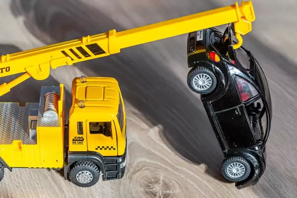 Yellow crane pulls black car - kids toys
