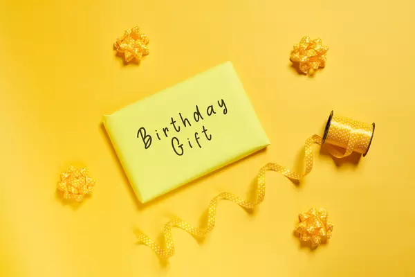 Yellow gift box on yellow background