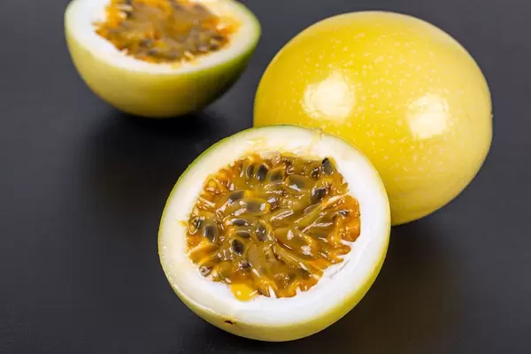 Yellow maracuja (passion fruit) on black background
