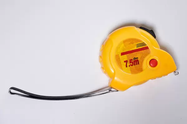 Yellow measuring tape from above