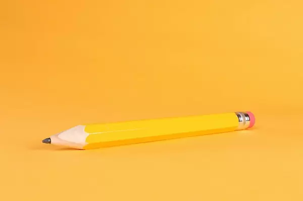 Yellow pencil on orange background