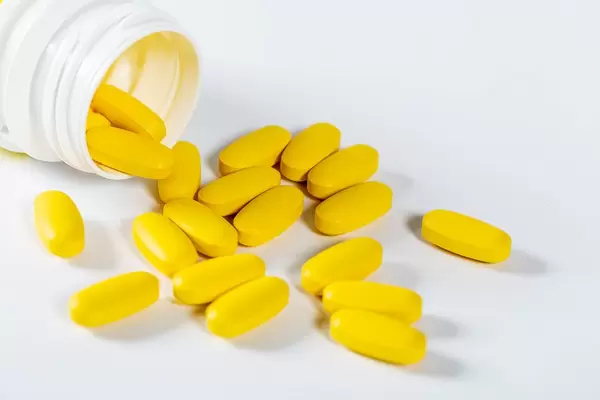 Yellow pills spilled out of the package