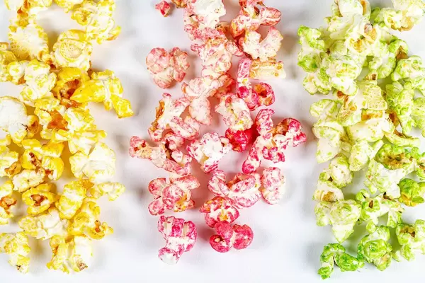 Yellow, red and green popcorn on a white background