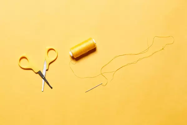Yellow sewing accessories on yellow