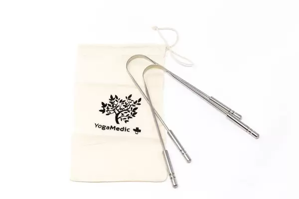 YogaMedic Tongue Scrapers for free tongue cleaning and a tiny jute bag on a white table