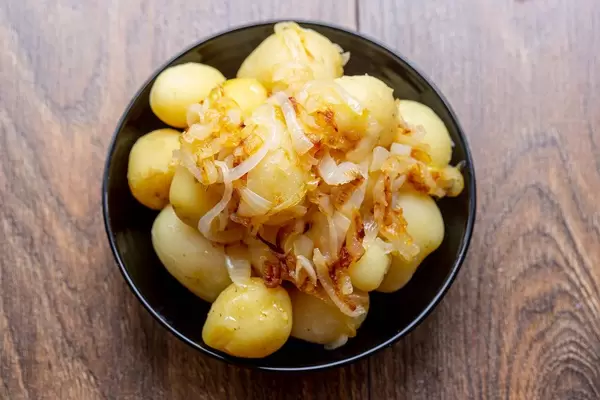 Young boiled potatoes with fried onions