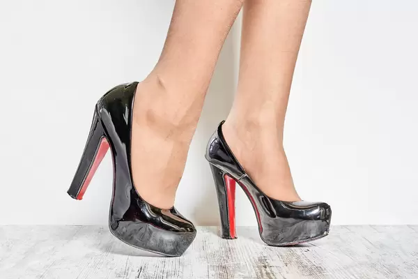 Young businesswoman wearing trendy Louboutin shoes