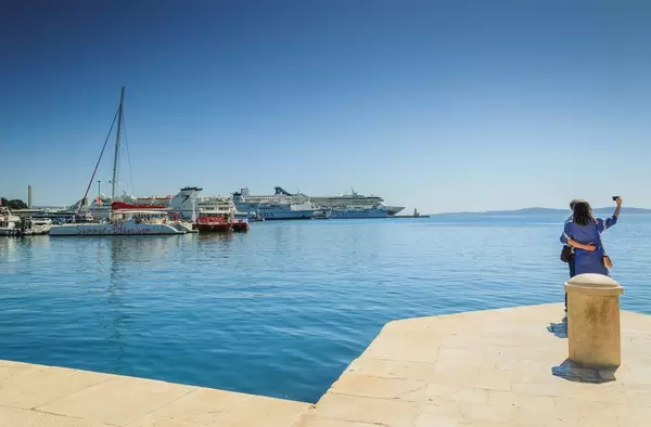 Young couple taking selfie on harbour, Split
