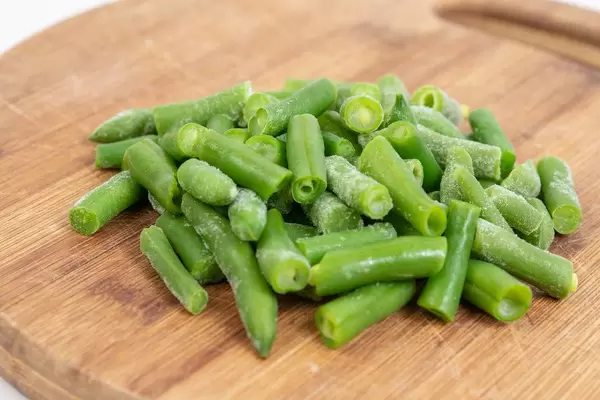 Young Green Beans on the wooden board