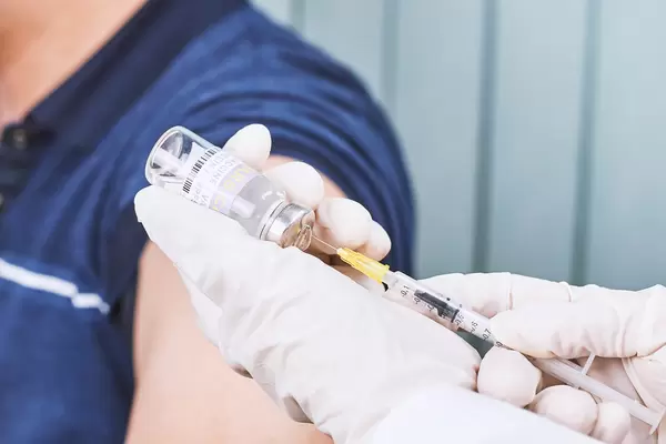 Young male getting intramuscular injection in arm