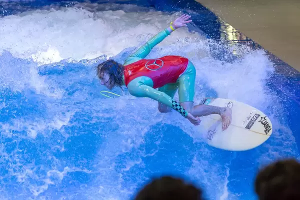 Young man trying out the surf machine Citywave at fair Boot Düsseldorf 2018