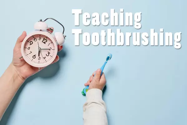 Young mother teaching her baby boy toothbrushing