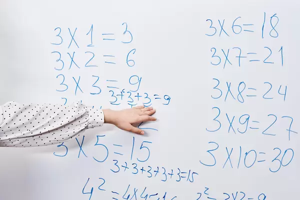 Young teacher explaining tricks for multiplication