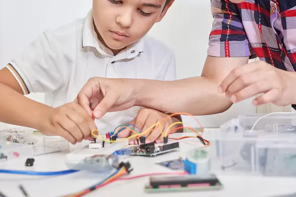 Young technicians building a robot