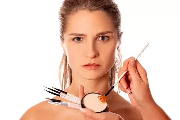 Young woman portrait in the process of makeup