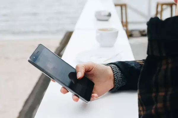 Young woman using smartphone. Outdoors