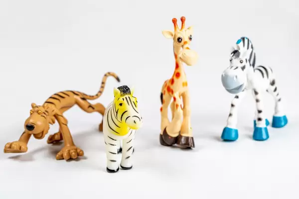 Zebra, giraffe and tiger toys on a white background