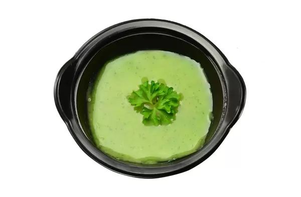 Zucchinisuppe in schwarzem Teller