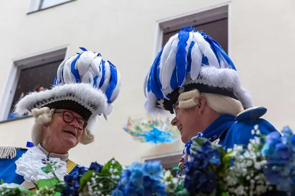 Zwei lächelnde Mitglieder der Blauen Funken im traditionellen blau-weißen Kostüm während des Rosenmontagsumzugs 2020 in Köln