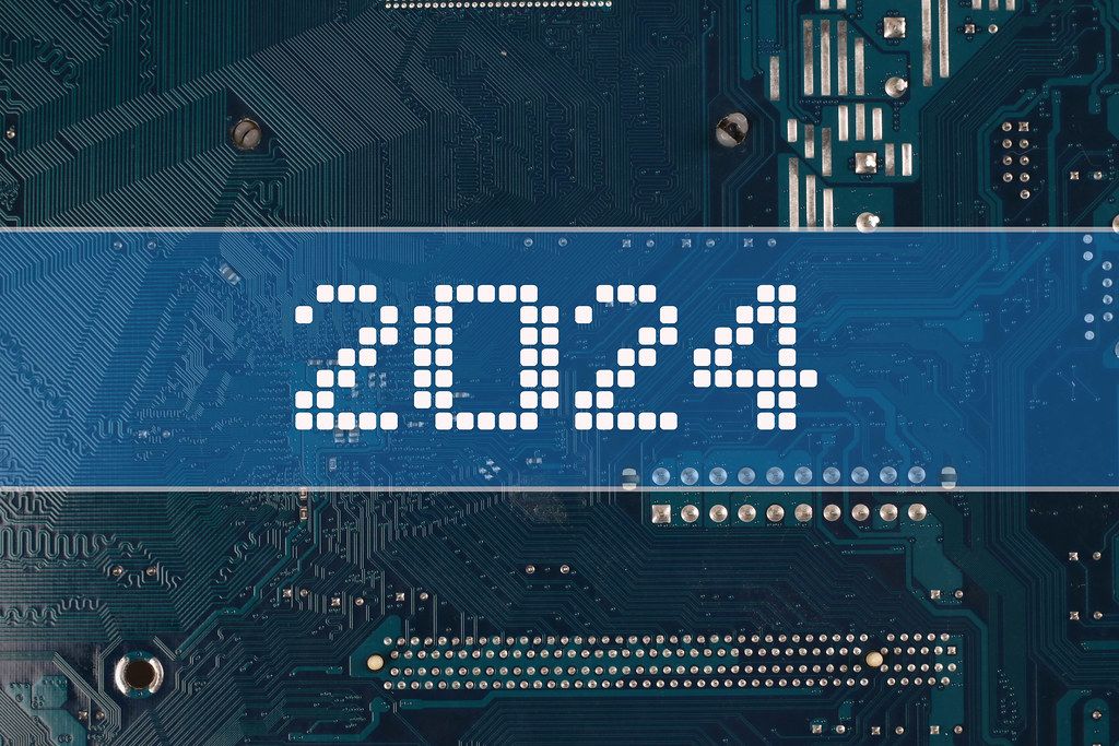 2024 text over electronic circuit board background Creative Commons