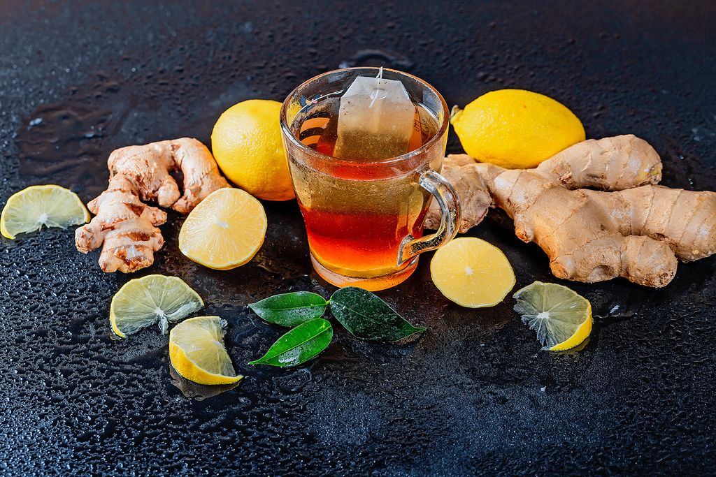 A cup of hot tea with lemon and fresh ginger root
