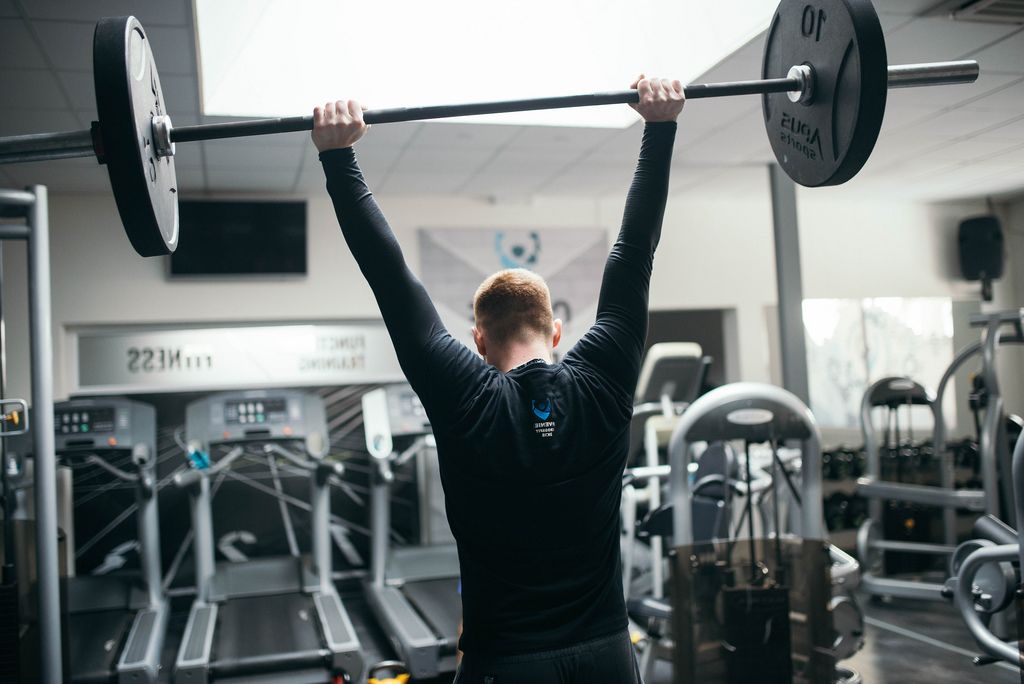A man lifting a weight at the gym  (Flip 2019) (Flip 2019) Flip 2019