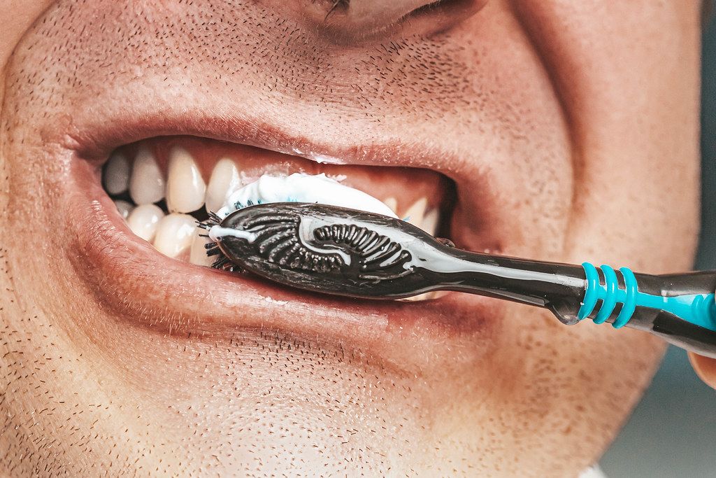 Adult man is cleaning his teeth with brush close up (Flip 2019)