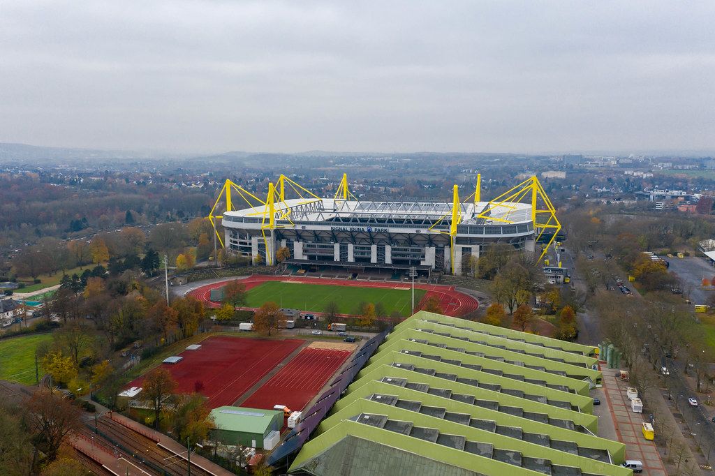 Aerial view of German football stadium Signal Iduna Park, outdoor soccer pitch and running track in Dortmund