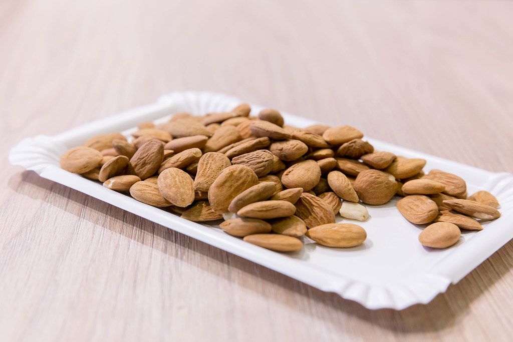 Almonds offered on a white paper plate at Fibo fitness days in Cologne