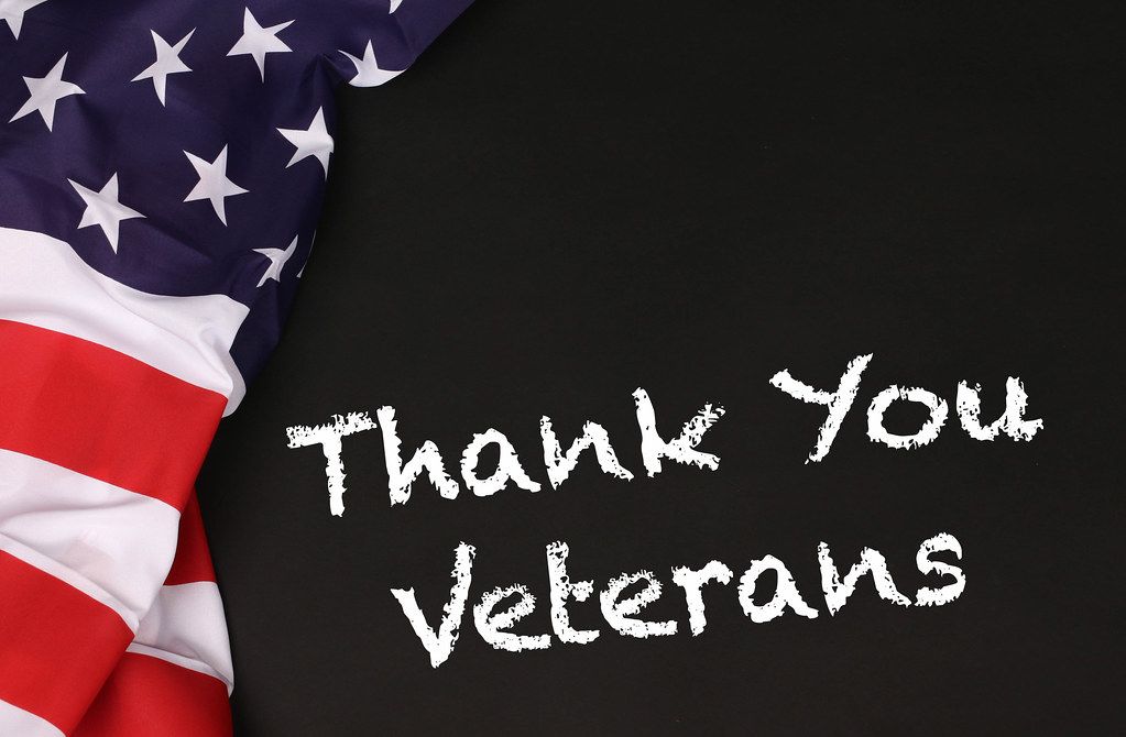 American flag with the text Thank You Veterans against a blackboard background.jpg