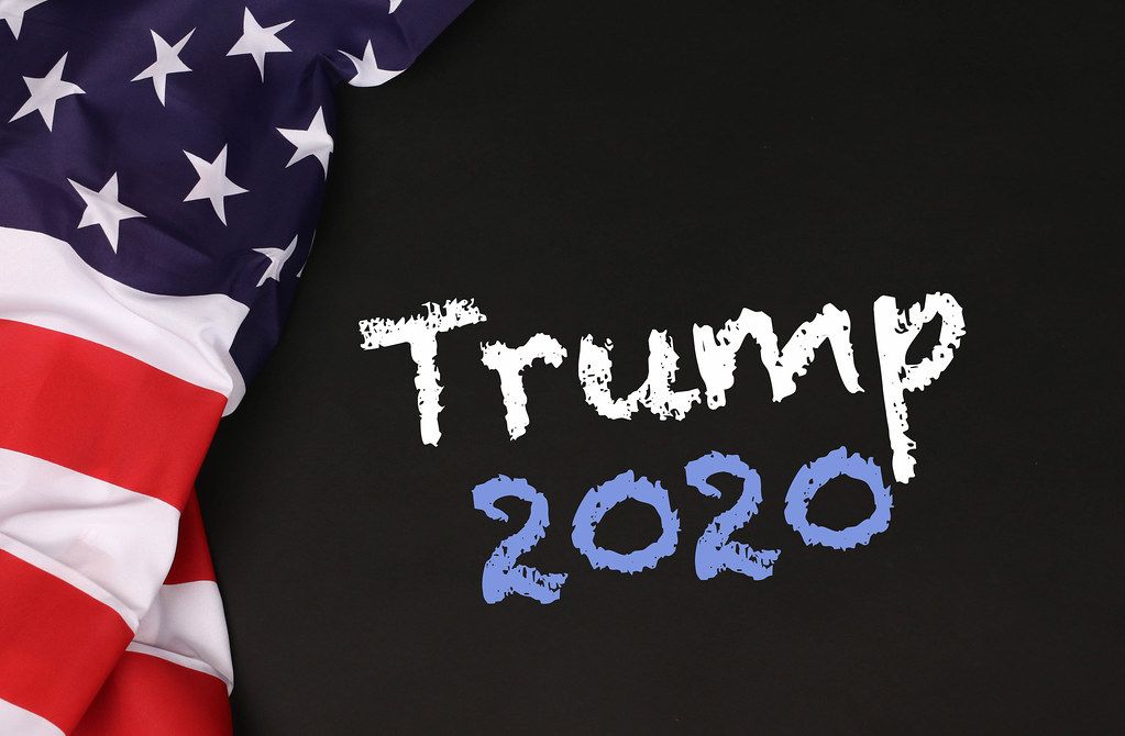 American flag with the text Trump 2020 against a blackboard background.jpg