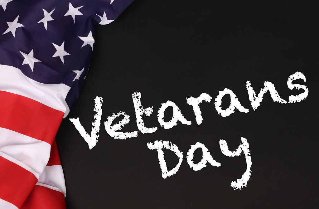 American flag with the Veterans Day text against a blackboard background.jpg