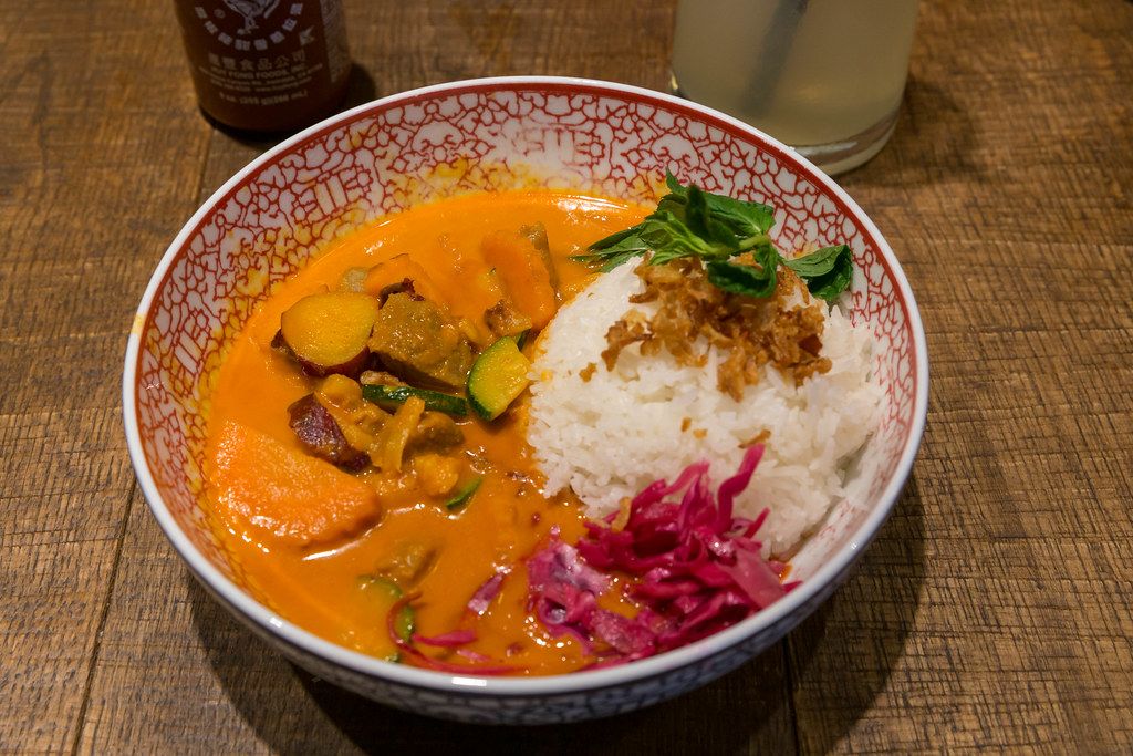 Asian food by at coa Restaurant: Red Hot Chili Curry with beef, sweet potatoes, zucchini, red cabbage, fried onions, carrots and jasmine rice