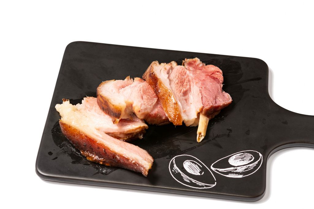 Baked delicious Pork Knuckle on black tray