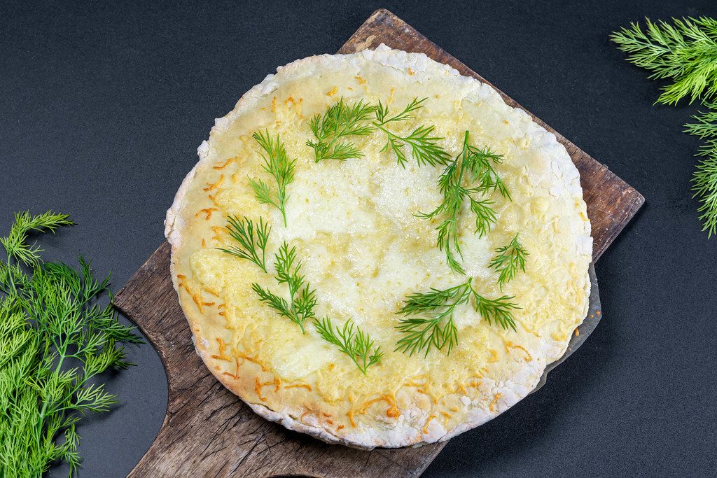 Baked meat pie with cheese and herbs