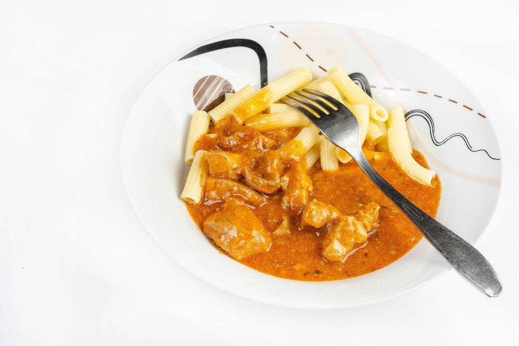 Beef Stew with Pasta above white background