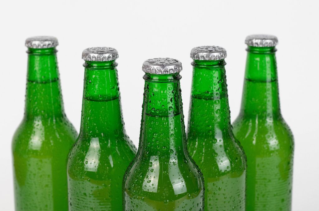 Beer bottles stacked isolated on white background