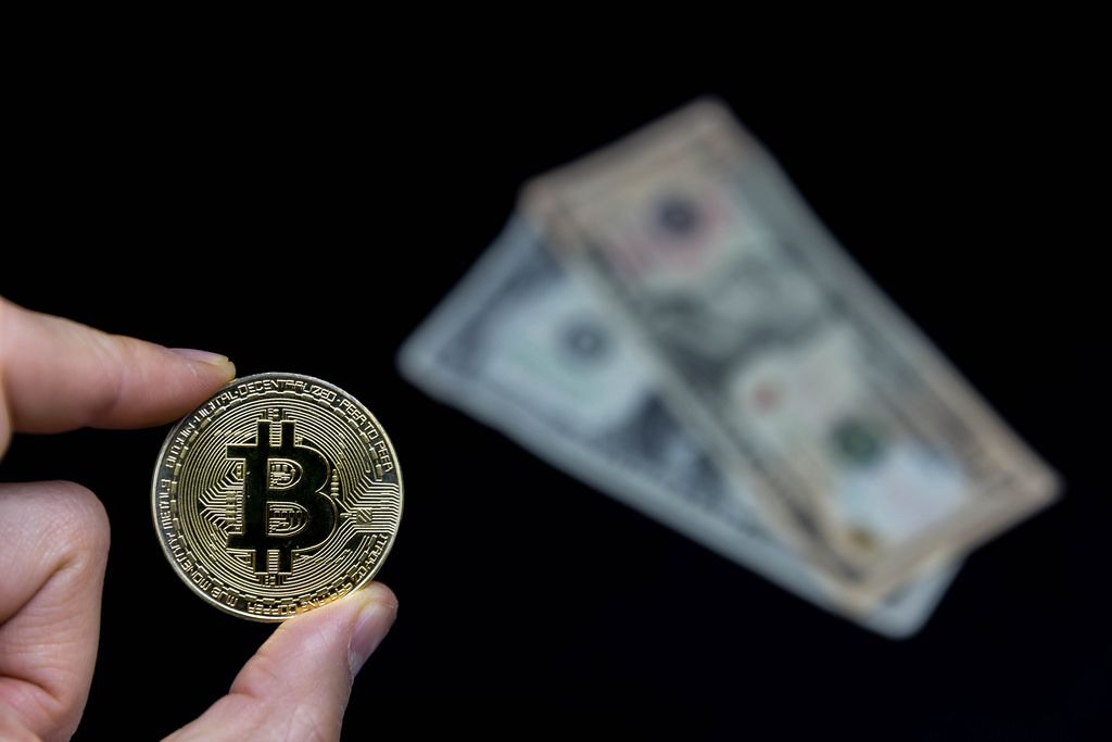 Bitcoin with Dollar in Background