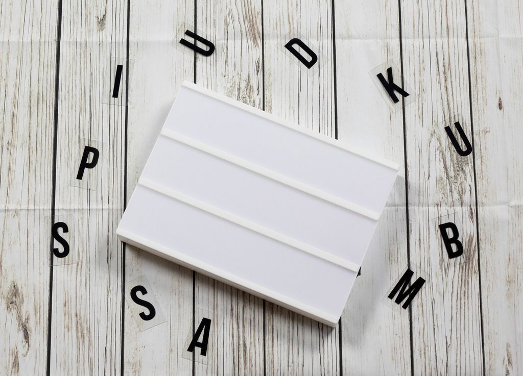 Blank lightbox sign on white wooden background