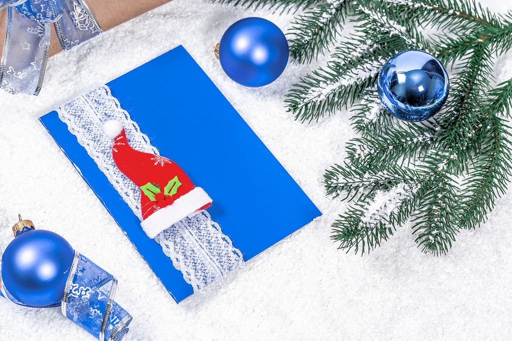 Blue Christmas Card with Christmas Hat and blue spheres and branches
